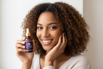 Person holding hair growth oil bottle and smiling